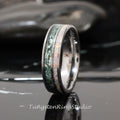 May include: A tungsten carbide ring with a green and white inlay. The ring is polished and has a beveled edge.