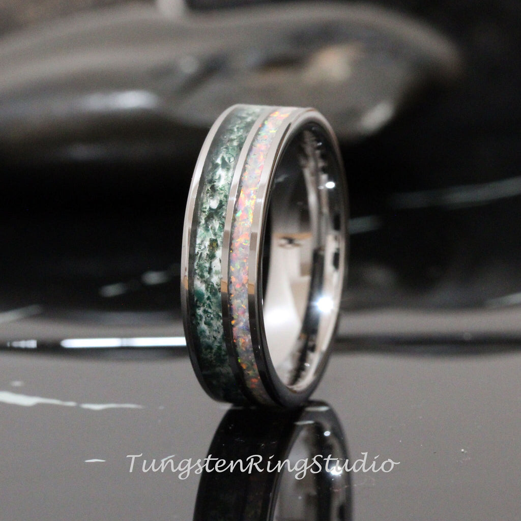 May include: A tungsten carbide ring with a green and white inlay. The ring is polished and has a beveled edge.