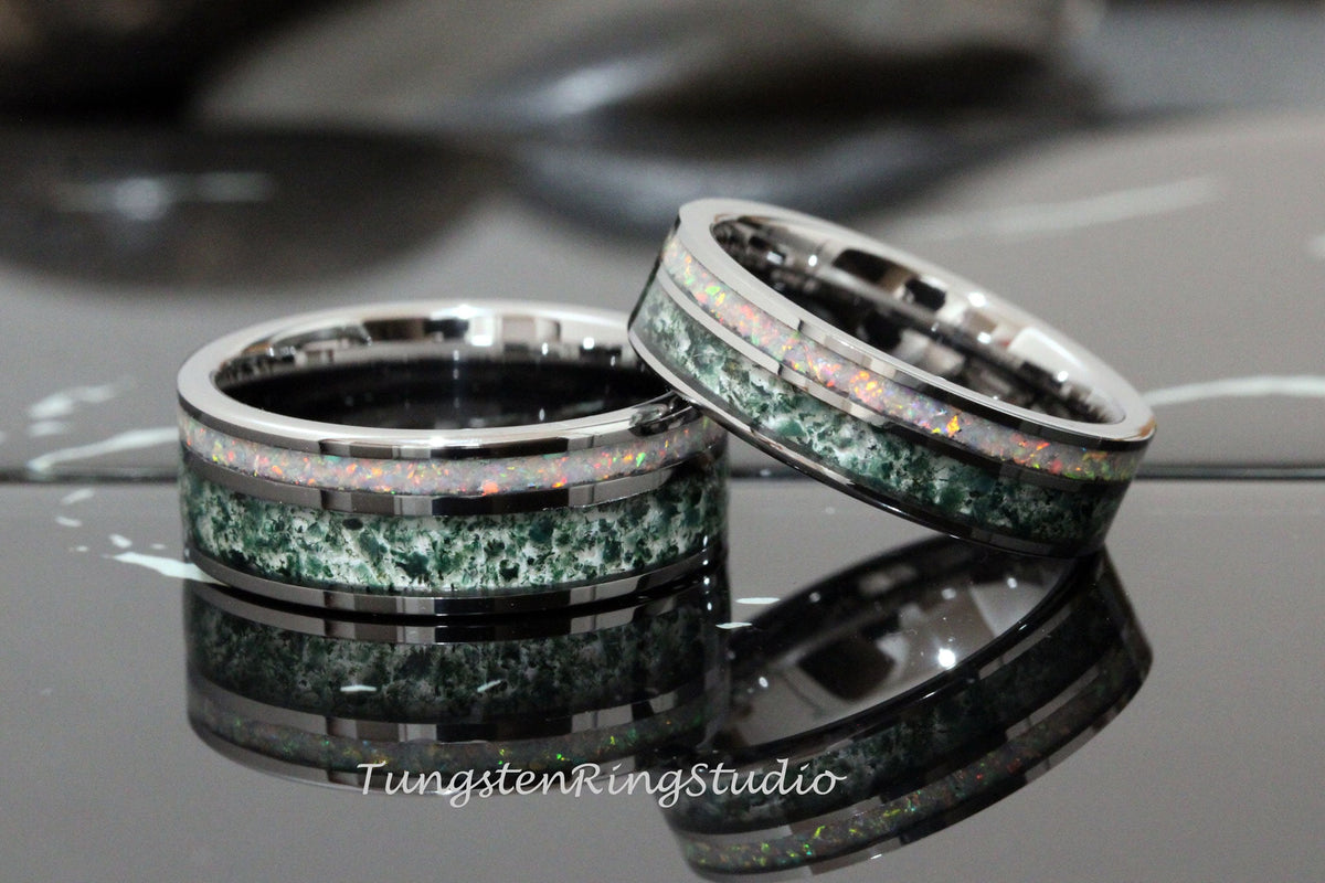 May include: Two silver tungsten carbide rings with green and white opal inlay. The rings are stacked on top of each other.