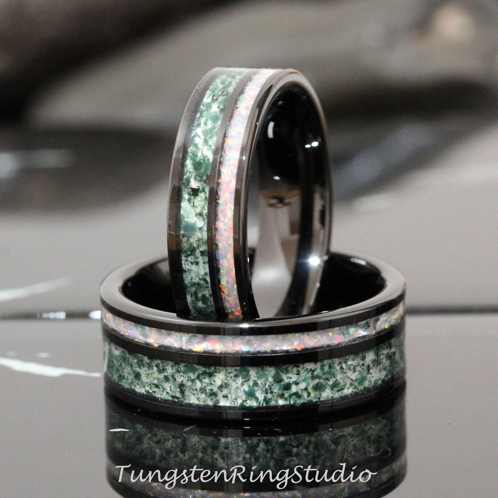 May include: Two black tungsten carbide rings with green and white inlay. The rings are stacked on top of each other.