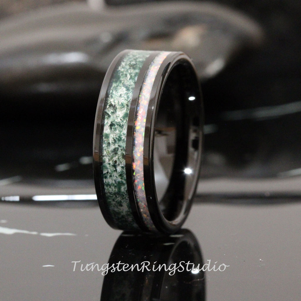 May include: Black tungsten carbide ring with a green and white inlay. The ring has a polished finish and a beveled edge.