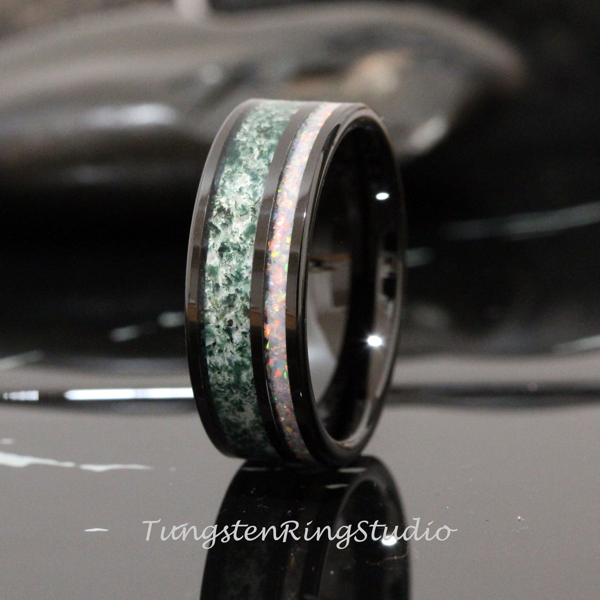 May include: Black tungsten carbide ring with a green and white inlay. The ring has a polished finish and a beveled edge.