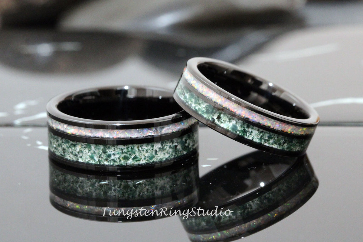 May include: Two black tungsten carbide rings with green and white inlay. The rings are stacked on top of each other.