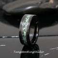 May include: A black tungsten carbide ring with a green and white inlay. The ring has a polished finish.