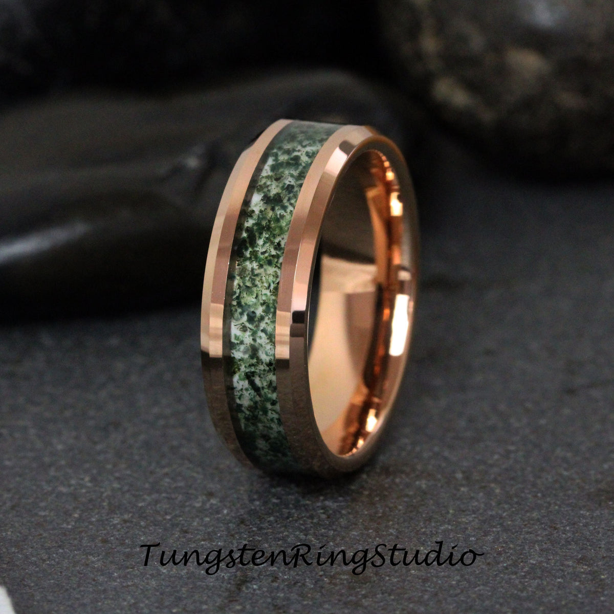 May include: A rose gold tungsten carbide ring with a green and white inlay. The ring has a beveled edge and a polished finish.