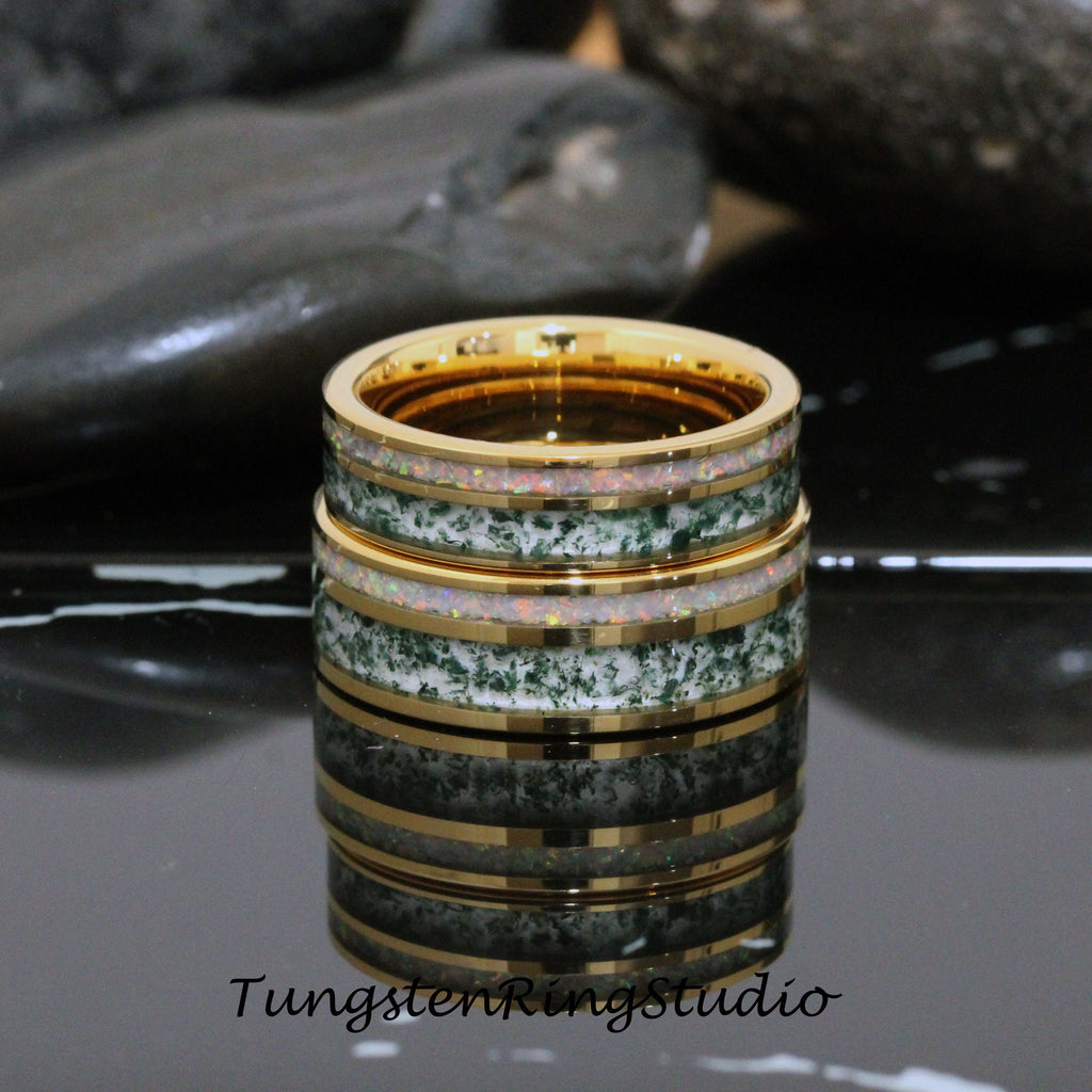 May include: Two stacked tungsten rings with a green and white inlay and gold trim. The rings are on a black surface.