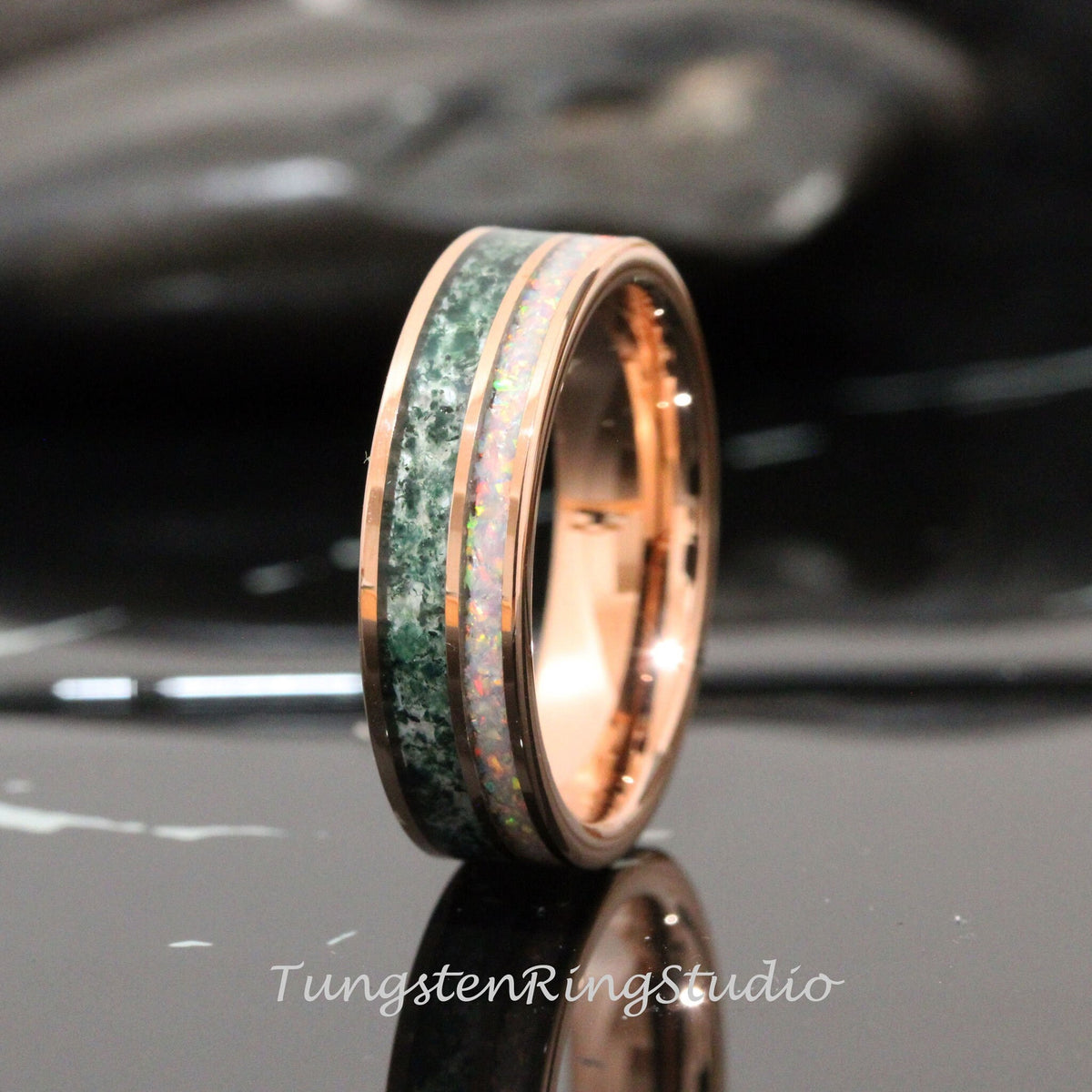 May include: A rose gold tungsten carbide ring with a green and white inlay. The ring has a polished finish and a beveled edge.