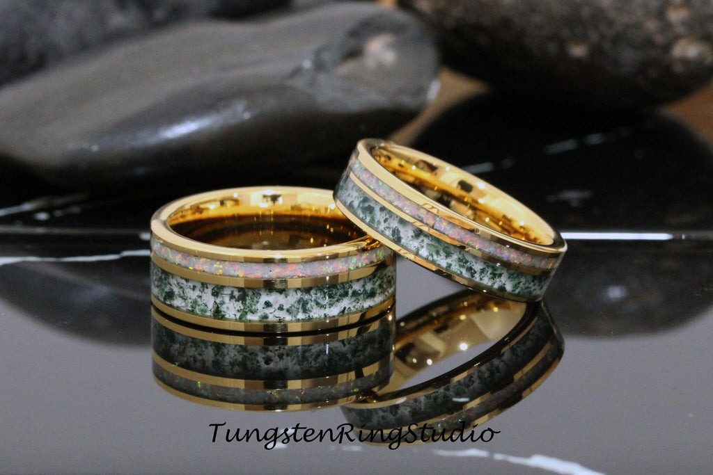 May include: Two gold tungsten carbide rings with a green and white inlay. The rings are stacked on top of each other.