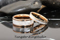 May include: Two tungsten carbide wedding bands with a rose gold inlay and a white mother of pearl inlay. The bands are stacked on top of each other.