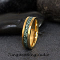 May include: A gold tungsten ring with a green and white inlay. The ring has a beveled edge and a polished finish.