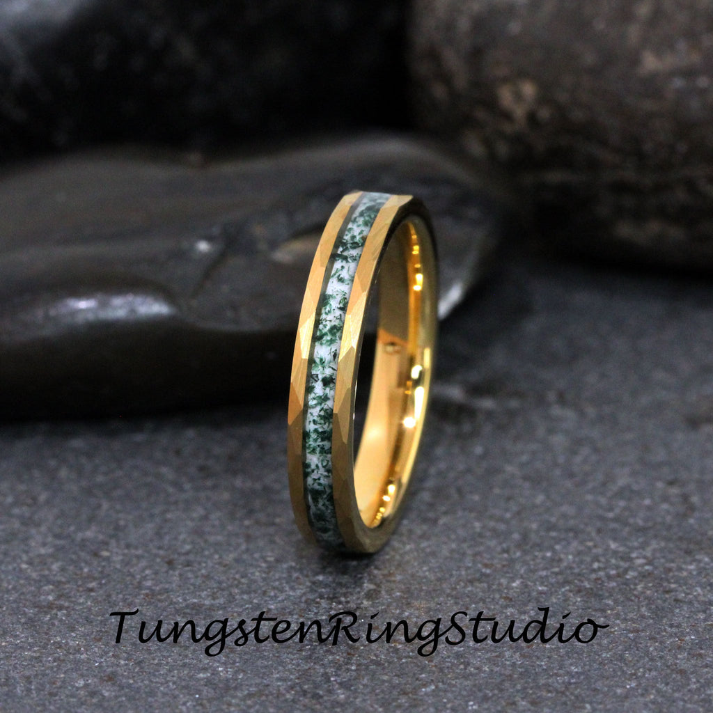 May include: A gold tungsten carbide ring with a green and white inlay. The ring has a beveled edge and is a popular choice for wedding bands.