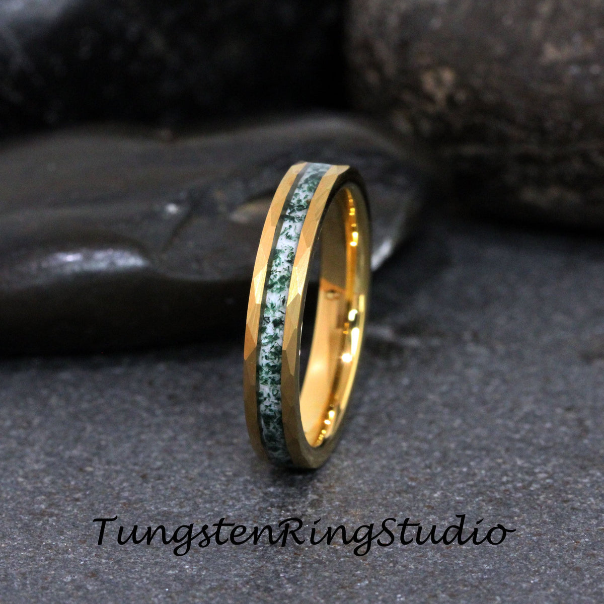 May include: A gold tungsten carbide ring with a green and white inlay. The ring has a beveled edge and is a popular choice for wedding bands.