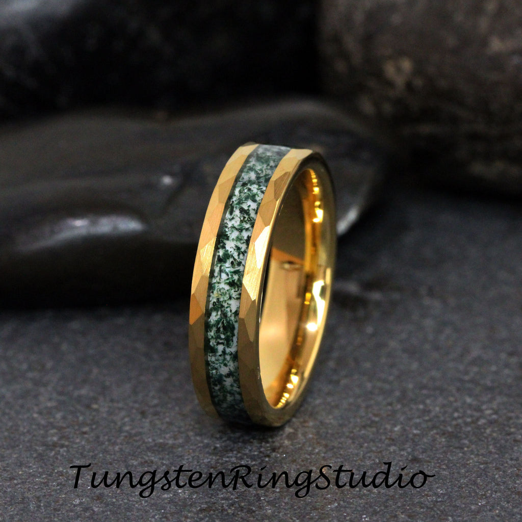 May include: A gold tungsten ring with a green and white inlay. The ring has a beveled edge and a polished finish.