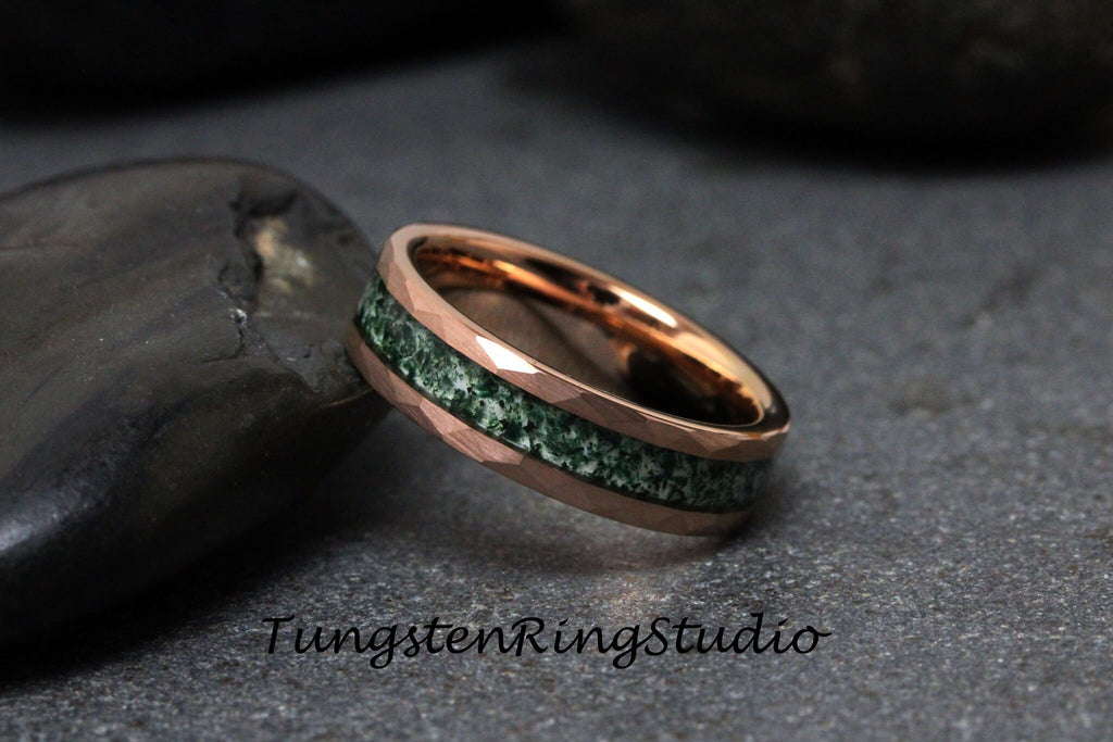 May include: Rose gold ring with a hammered texture and a green stone inlay. The ring is set against a dark background. The text "TungstenRingStudio" is visible in the image.