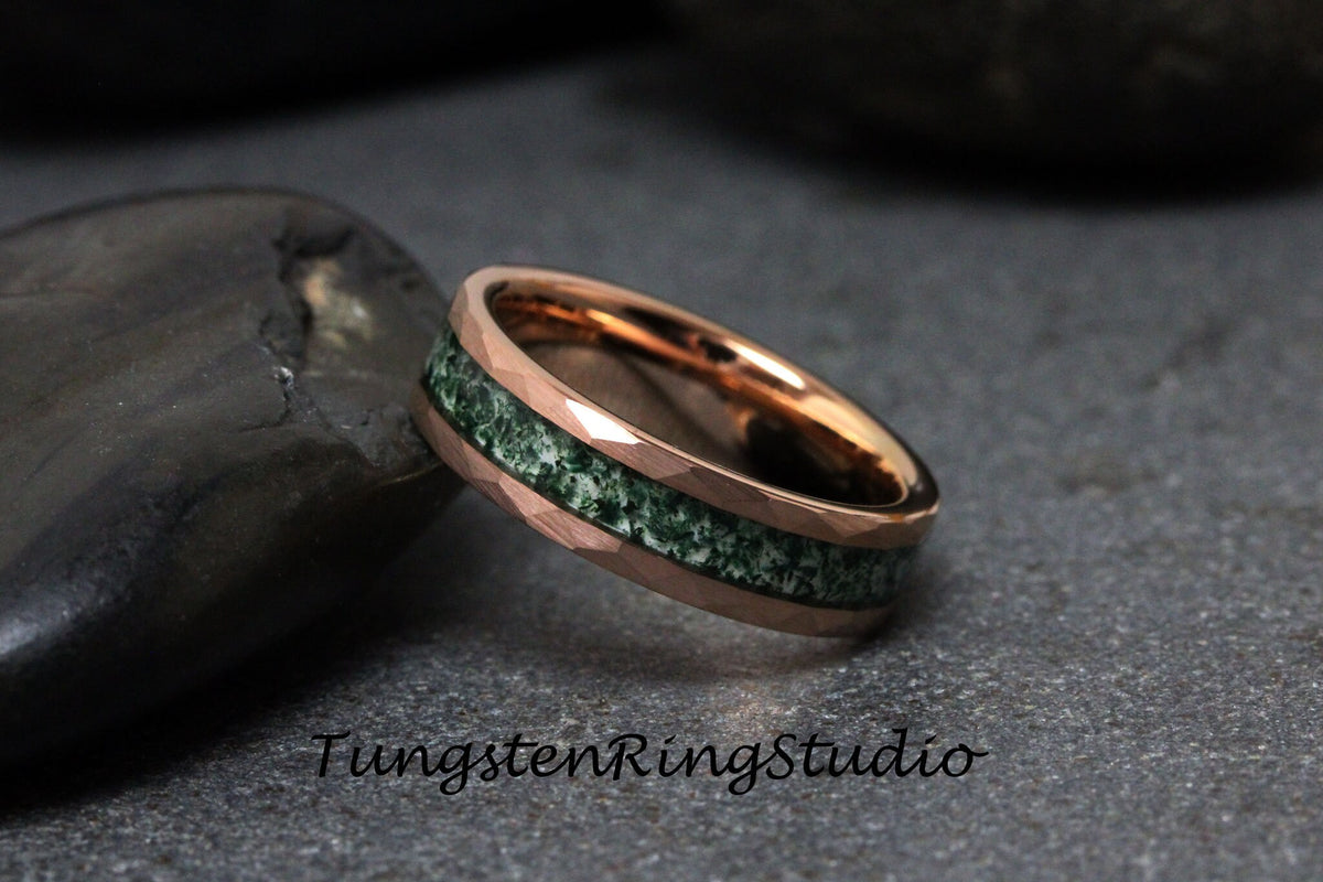 May include: Rose gold ring with a hammered texture and a green stone inlay. The ring is set against a dark background. The text "TungstenRingStudio" is visible in the image.