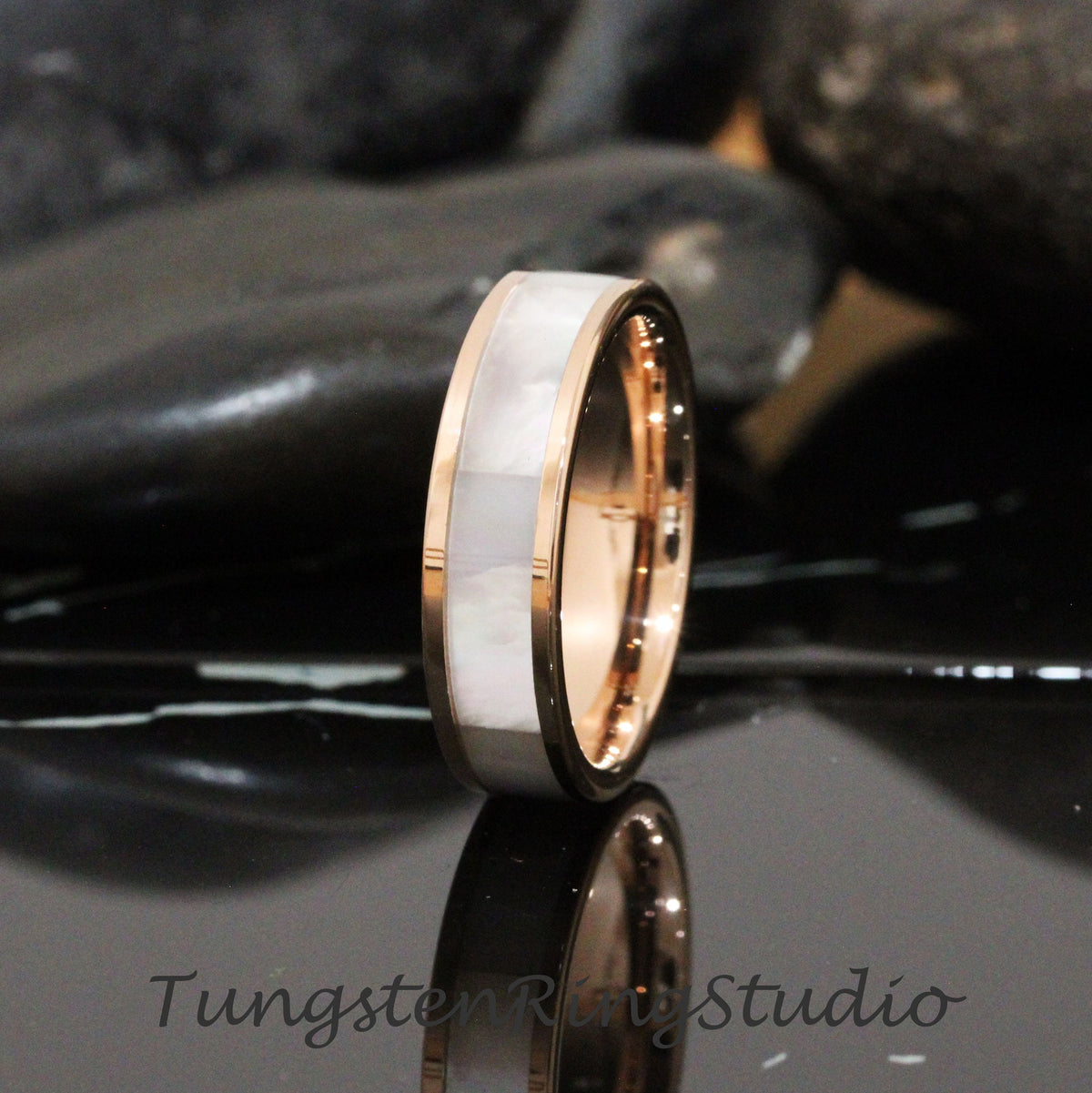 May include: A rose gold tungsten carbide ring with a white mother-of-pearl inlay. The ring is 8mm wide and has a polished finish.