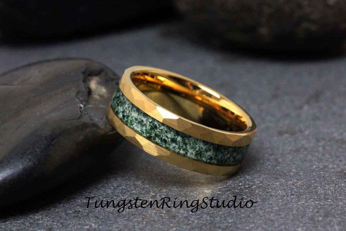 May include: A gold tungsten carbide ring with a green and white inlay. The ring has a hammered finish.