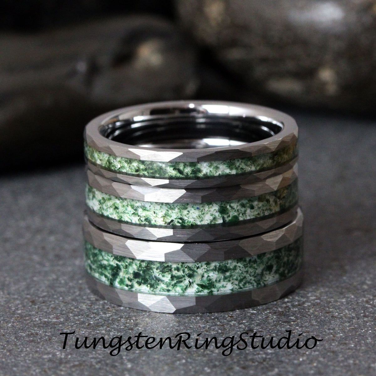 May include: Stack of tungsten rings with a hammered finish and inlaid green stone. The rings have a silver color and the text "TungstenRingStudio" is visible at the bottom.