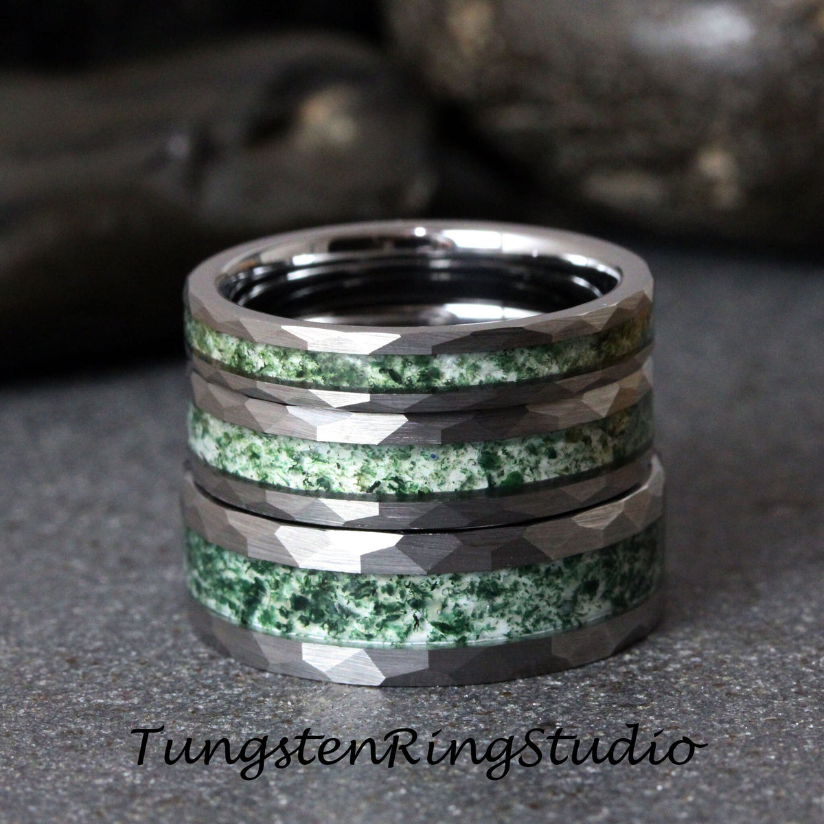 May include: Four stacked tungsten carbide rings with a green and white inlay. The rings have a faceted, beveled edge.