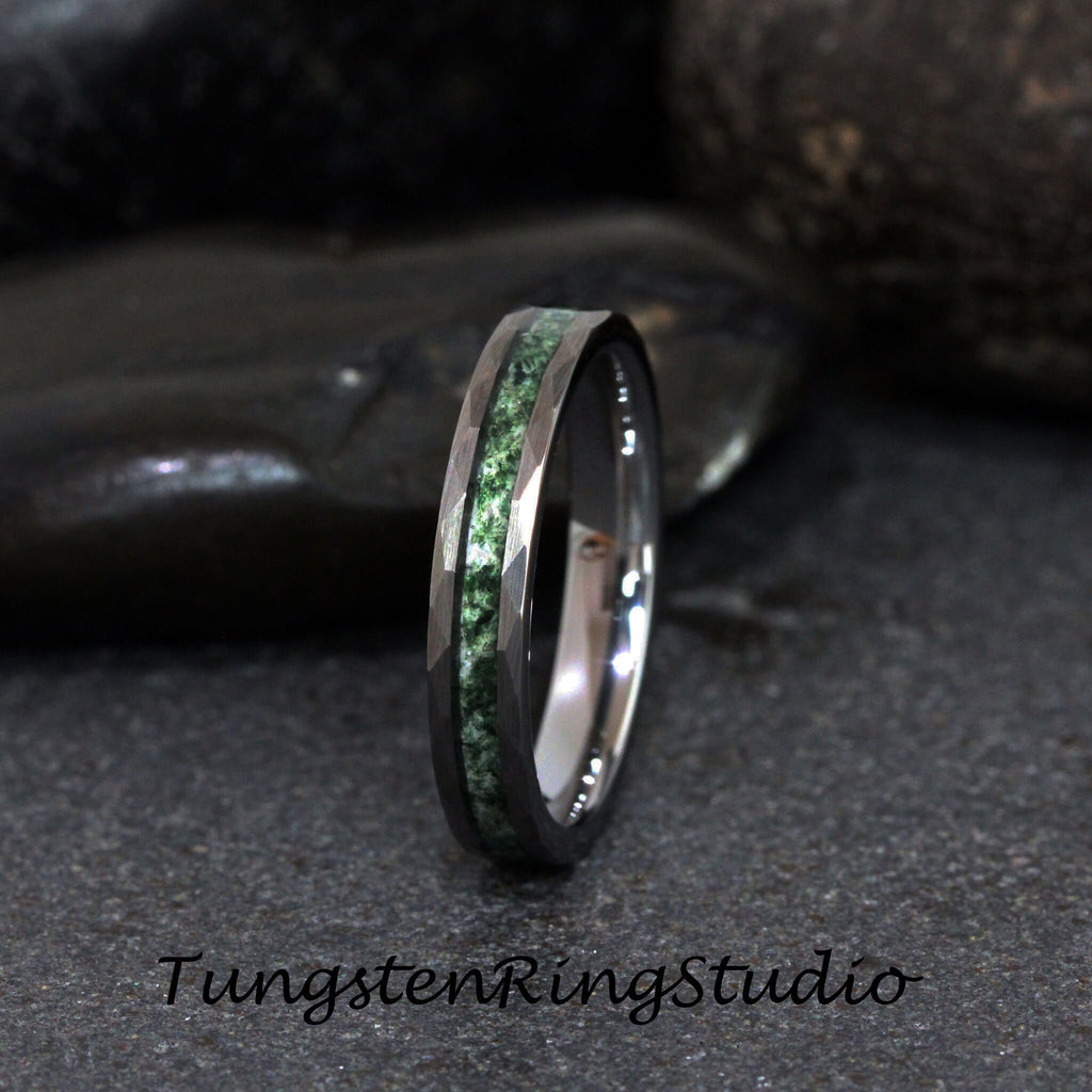 May include: A silver tungsten ring with a green inlay. The ring has a beveled edge and a polished finish.