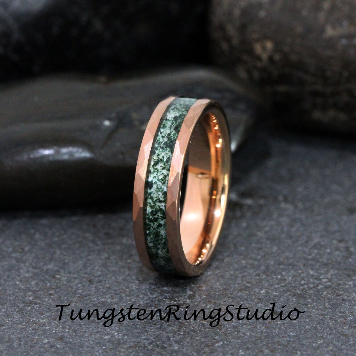 May include: Rose gold ring with a hammered finish and a green stone inlay. The ring features the text "TungstenRingStudio" at the bottom. The ring is set against a dark background.