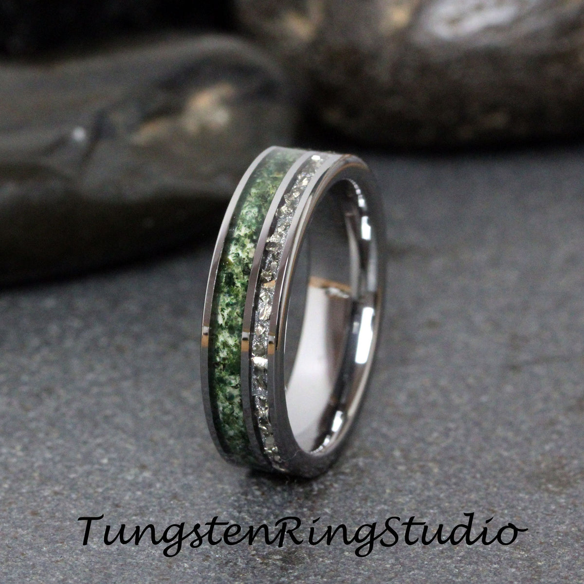 May include: A silver tungsten ring with a green inlay and a row of clear cubic zirconia stones.