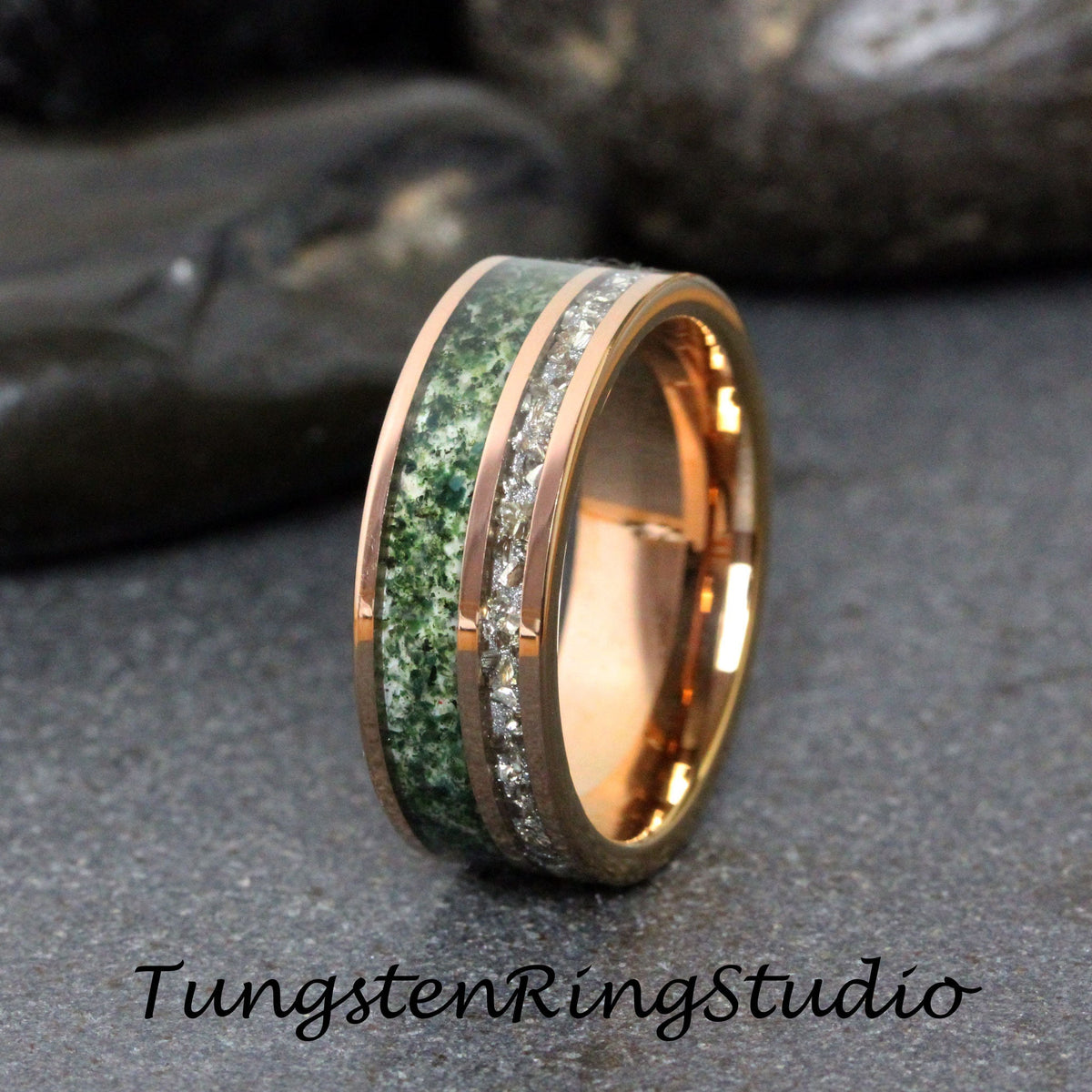 May include: Rose gold wedding band with a green stone inlay and a silver-colored stone inlay. The ring has a polished finish and the text "TungstenRingStudio" is visible.