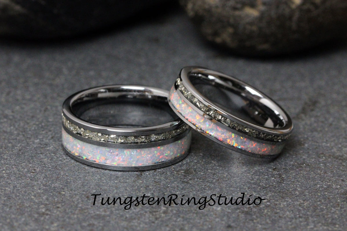 May include: Two silver tungsten carbide rings with a white opal inlay and a row of small diamonds. TungstenRingStudio.
