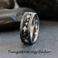 May include: A silver and black tungsten carbide ring with a hammered finish and a silver inlay. The ring has a black background with silver flecks.