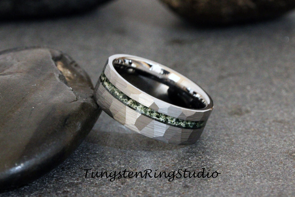 May include: A silver tungsten ring with a hammered finish and a green inlay. The ring is on a gray background.