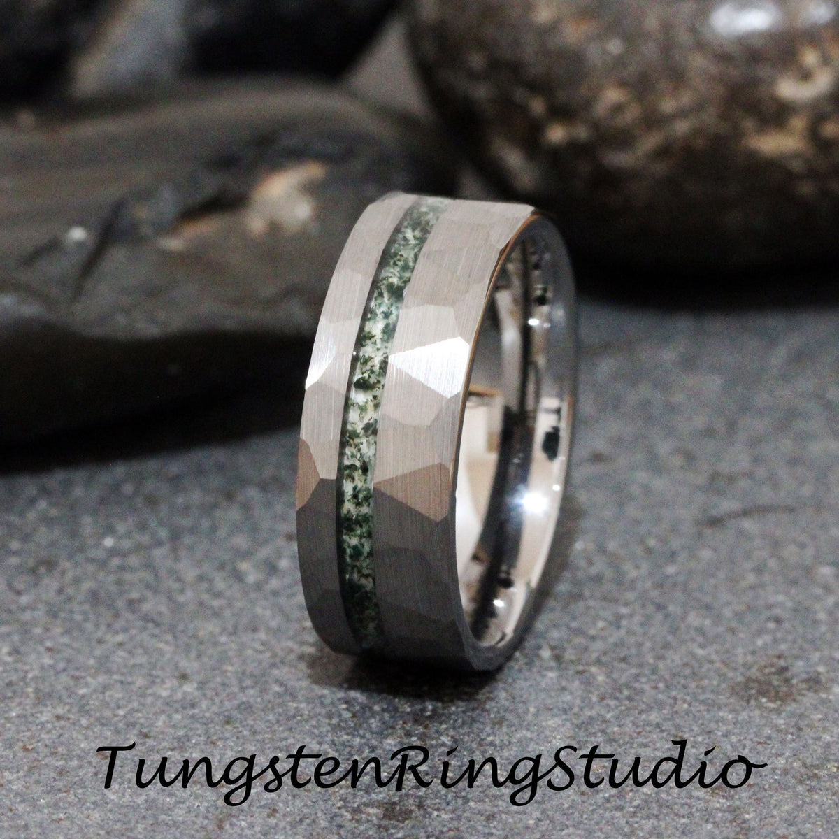 May include: A silver tungsten carbide ring with a hammered finish and a green stone inlay. The ring is approximately 8mm wide.