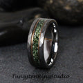 May include: A tungsten carbide ring with a hammered finish and a green and copper inlay. The ring is a dark gray color.