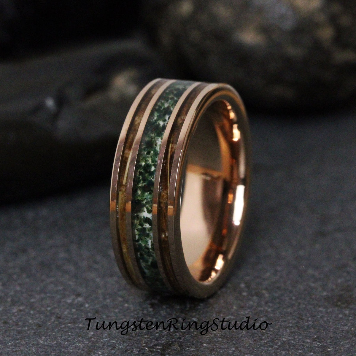May include: Rose gold ring with a central band of green stone and two parallel rose gold bands. The ring has a polished finish and the text "TungstenRingStudio" is visible at the bottom.