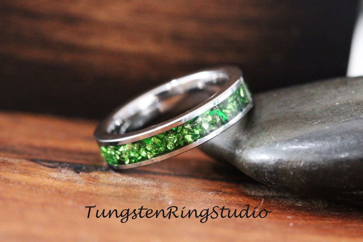 May include: A silver tungsten ring with a band of green glitter embedded in the metal.