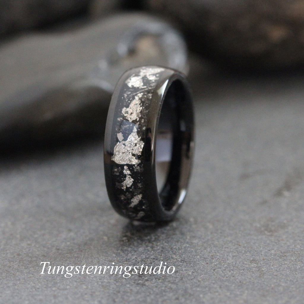 May include: Black tungsten carbide ring with silver flakes embedded in the band.