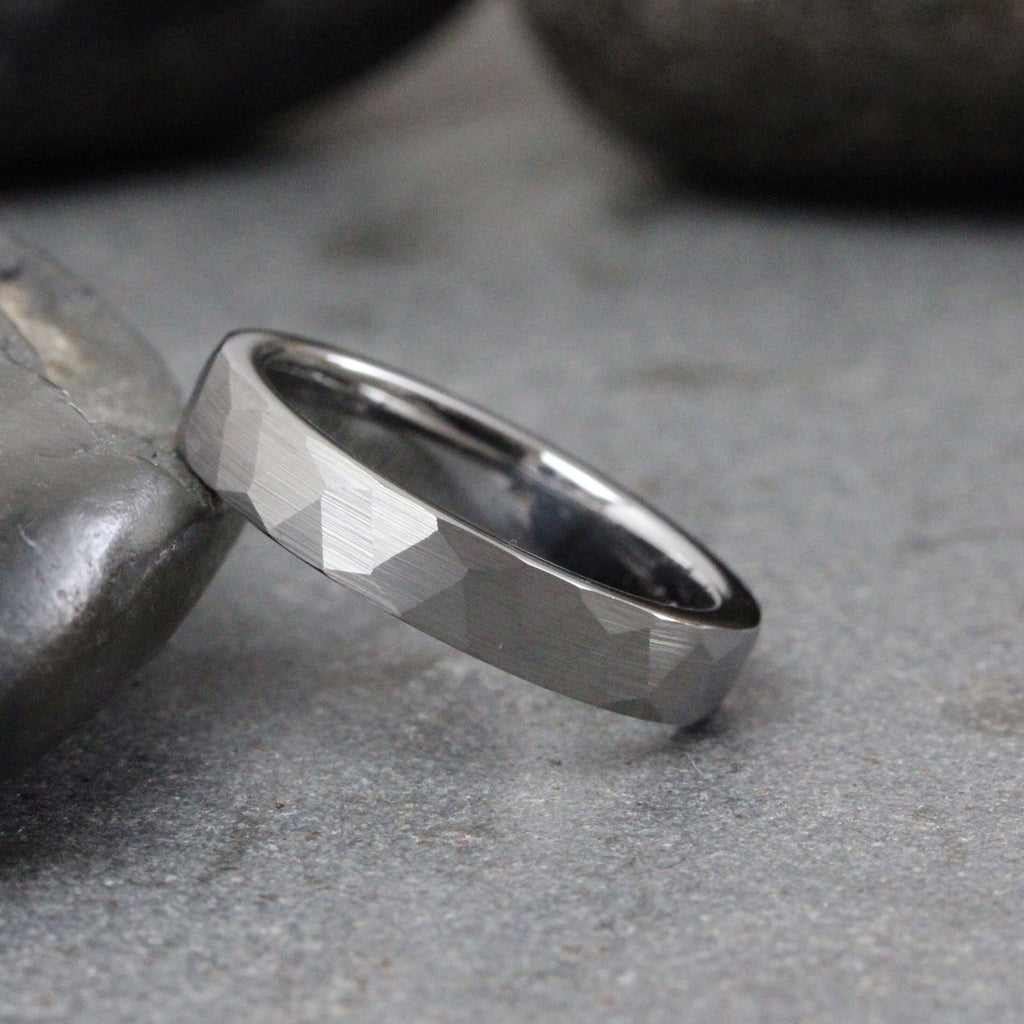 May include: A silver-toned, hammered, wedding band ring.