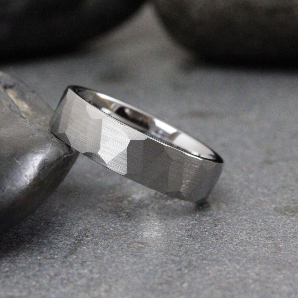 May include: A silver hammered wedding band with a brushed finish.