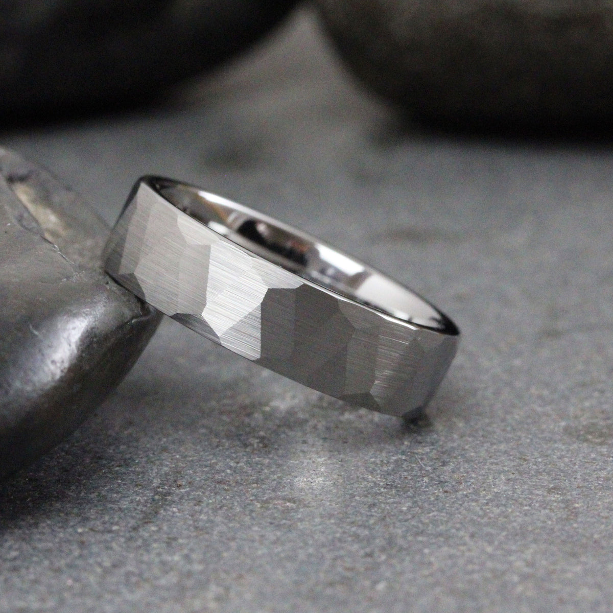 May include: A silver hammered wedding band with a brushed finish.