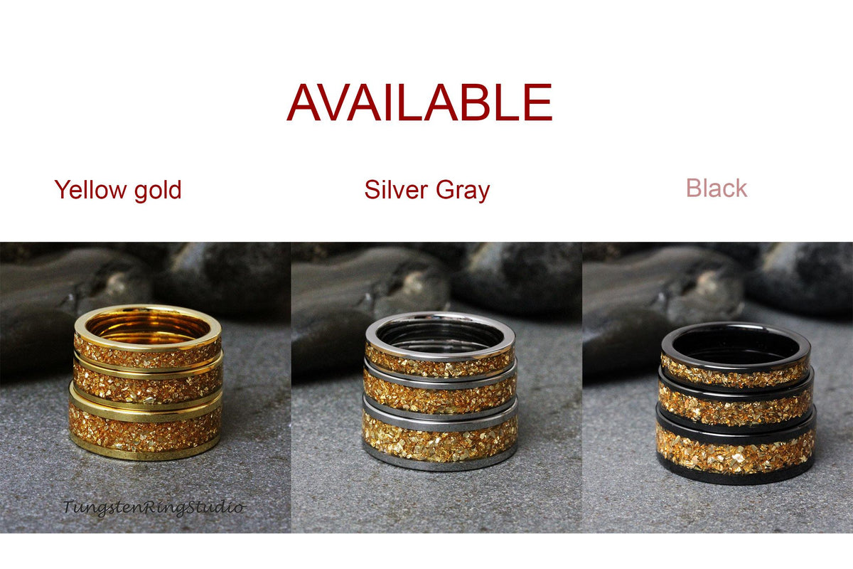 May include: Three stacked rings with a gold glitter finish. The rings are available in yellow gold, silver gray, and black.