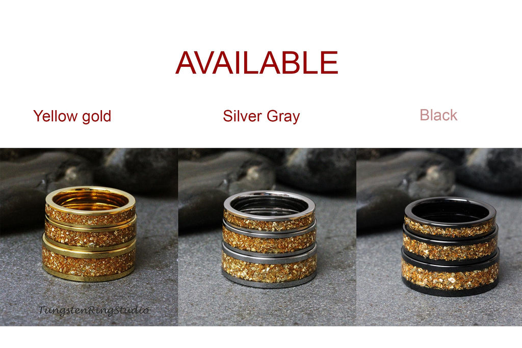 May include: Three stacked rings with a gold glitter finish. The rings are available in yellow gold, silver gray, and black.