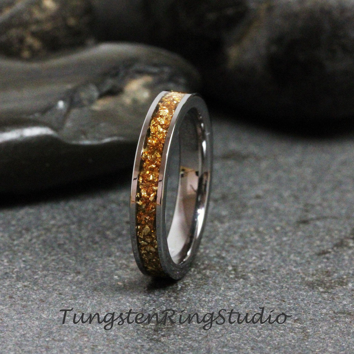 May include: A silver tungsten ring with a band of gold flecks.