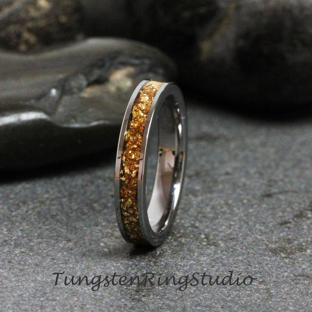 May include: A silver tungsten ring with a band of gold flecks.