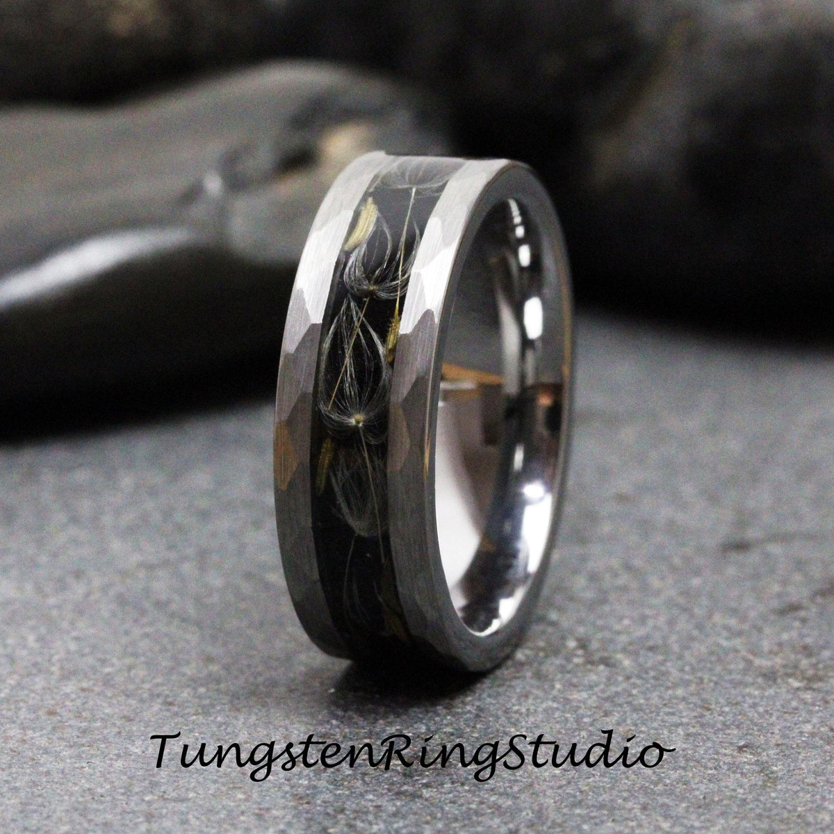 May include: A silver tungsten ring with a black and white dandelion design. The ring has a hammered finish.