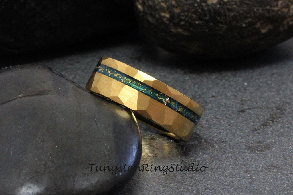 May include: Gold tungsten carbide ring with a blue and gold inlay. The ring has a hammered finish.