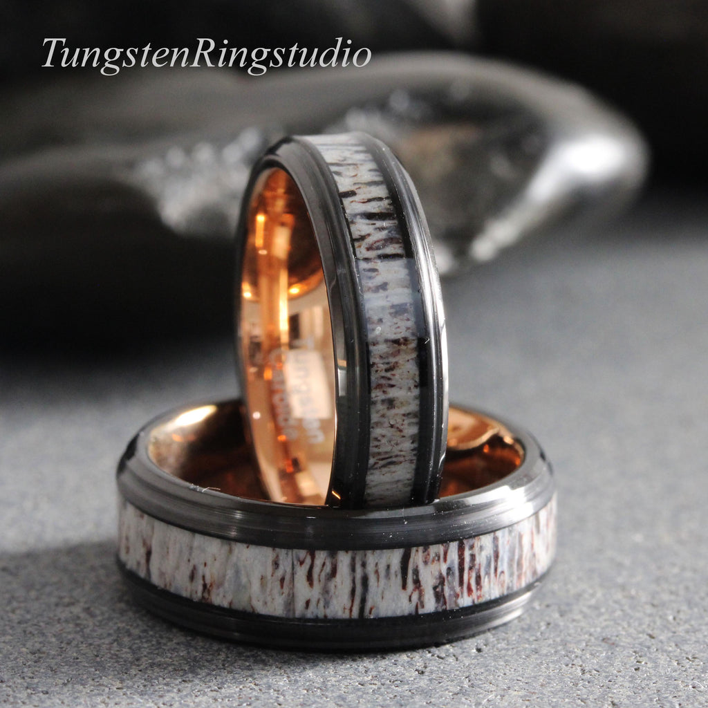 May include: Two rings featuring a black metal band with a central inlay of textured, light-colored antler material. The interior of each ring has a polished rose gold finish. The text TungstenRingstudio is visible in the upper left corner.